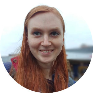 Site author photo: a smiling trans woman with red hair.